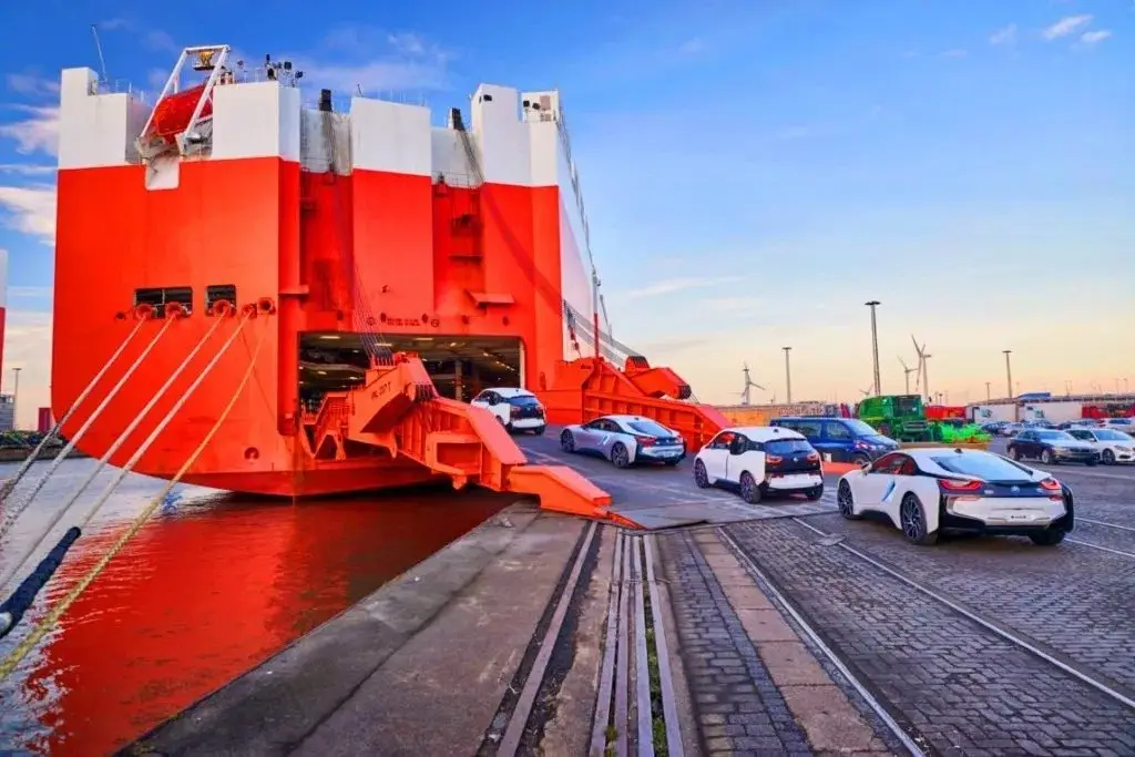 Cars driving up the ramp of a RoRo vessel bound for Africa